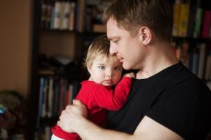 man holding baby concerned about child support