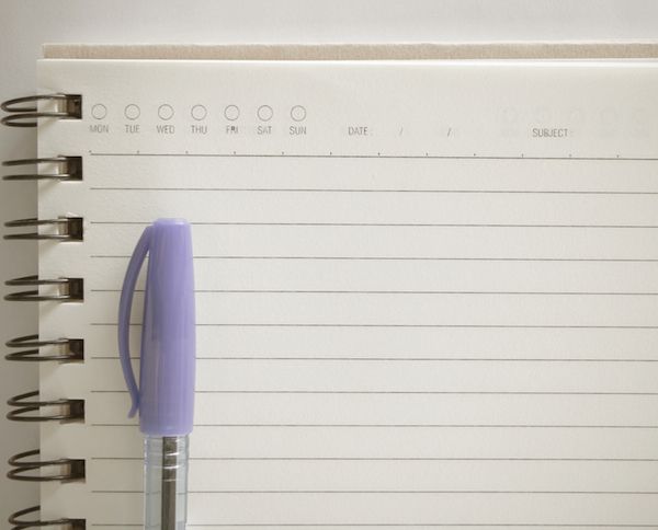 open notebook with pen with purple cap