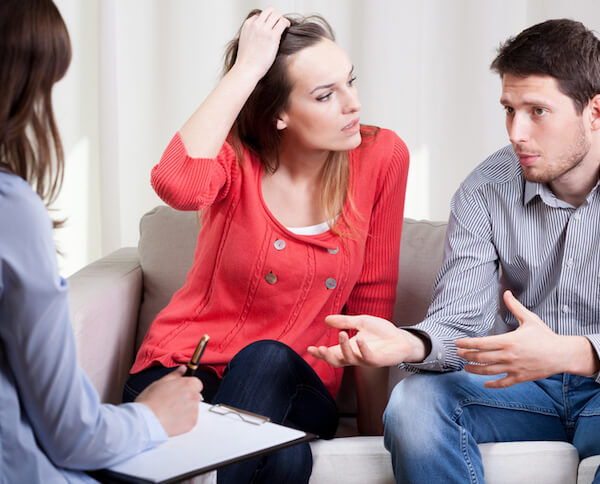 types of collaborative divorce professionals couple in therapy in therapist office arguing