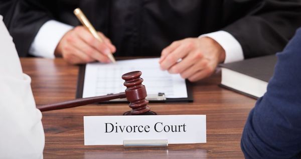 couple sitting at desk in divorce court