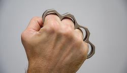Brass knuckles on a fist