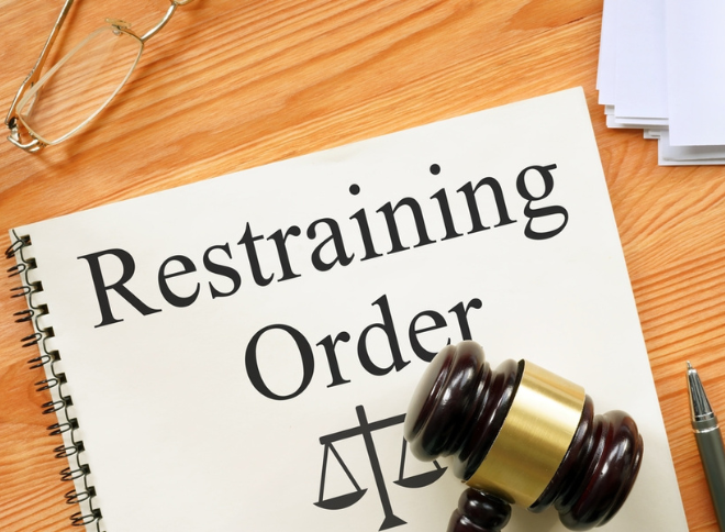 Restraining order written on a piece of paper