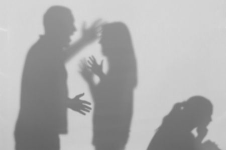 Shadows of a married couple in a fight preceding domestic violence